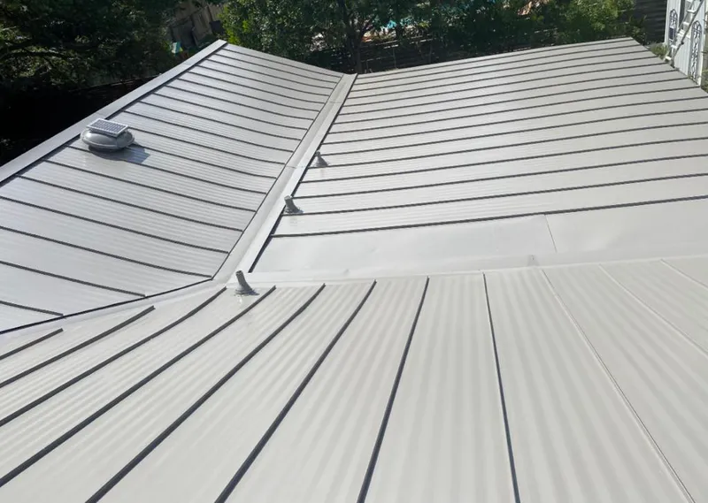 Solar attic fan installed on a metal roof for Roof Ventilation in Waveland